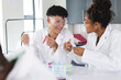 © Wavebreak Media - Teenage biracial boy and teenage biracial girl in a lab at high school, with
