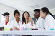 © Wavebreak Media - Diverse students engage in a science experiment at high school