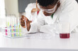© Wavebreak Media - Teenage biracial boy conducts an experiment in a high school lab