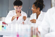 © Wavebreak Media - Teenage biracial students conduct an experiment in a high school lab