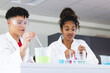 © Wavebreak Media - Teenage biracial boy and teenage undefined girl in a lab setting in high school