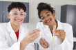 © Wavebreak Media - Teenage biracial boy and teenage biracial girl in a lab setting at high school