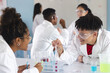 © Wavebreak Media - Diverse students engage in a chemistry experiment at high school