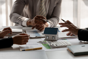 accommodation agency and client are planning together about finance because the client wanted to buy a house, meeting in property office with expert of how to find the best house for rent