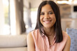 © Wavebreak Media - A biracial young girl smiling at home, wearing light pink shirt