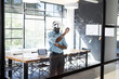 © Wavebreak Media - Young African American man in business office using VR headset, engaging with virtual screen