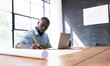 © Wavebreak Media - At modern business office, young African American man working on architectural drawings