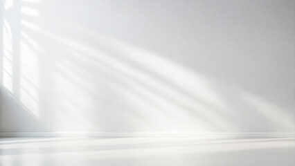 minimalistic light background with blurred foliage shadow on white wall