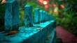 © Mikus - A tight shot of a weathered wooden fence Behind it, trees and distant lights blur softly In the foreground, a bench and foliage reside beyond the fence