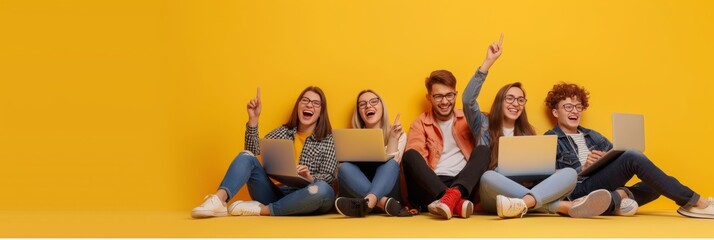 A diverse group of young adults celebrates success with laptops on a bright yellow backdrop, showcasing teamwork in the digital age. The scene radiates happiness and modern youth culture energy