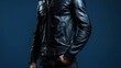 © Salman - Male fitness model in a sleek black leather jacket with dark jeans, isolated on an indigo background