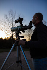 Wall Mural - amateur astronomer observing sun eclipse and sun with a telescope and special solar filter.