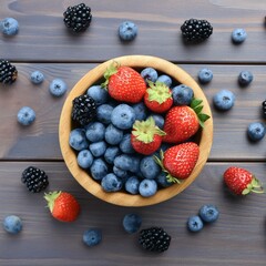 Wall Mural - a bowl of mixed strawberries, blueberries, raspberries and blackberries on a wooden table