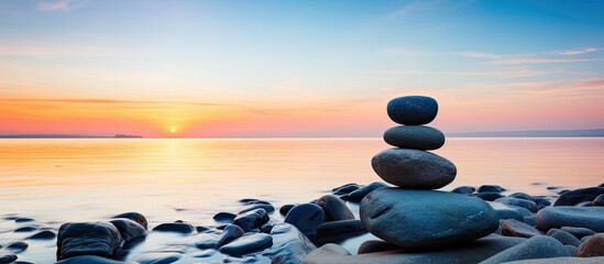 Sticker - Zen stones on the beach at sunset embody the peaceful concepts of harmony and meditation, with a serene copy space image.