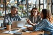 © WMSTUDIO - A close-up shot of a financial advisor explaining investment strategies to a couple. The advisor points to a pie chart on a laptop screen while the couple, appearing engaged, listens carefully. The