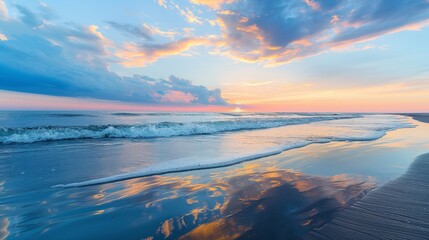 Wall Mural - A serene beach at sunset with gentle waves creating a mirror image of the colorful sky and distant horizon on the wet sand.