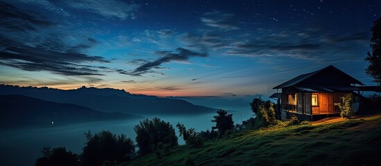 Wall Mural - capture a house with a long exposure against the dark night sky in a copy space image.