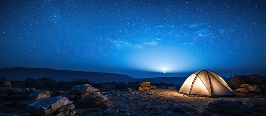 Wall Mural - night view of the milky way galaxy over a desert landscape in israel with ample copy space image.