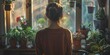 © Adobe Contributor - woman looking out the window at her plants