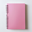 © Nasreen - A pink notebook placed in the bottom right corner of a solid white background, ready for note-taking.