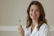 © StockLab - A female in a white coat is seen holding a vaccine bottle, set against a light plain backdrop