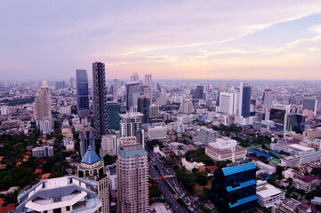 Wall Mural - Sunset in megalopolis. Beautiful cityscape with top view on skyscrapers. Bangkok, Thailand.