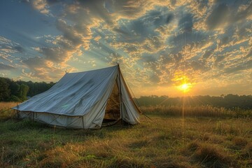 Poster - A tent in a field at sunset, great for outdoor adventure or camping scenes