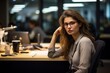 © MediaRaw - A woman wearing glasses sits at a desk with a laptop and a cup
