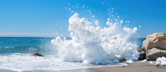 Poster - Rough White Ocean Foam Crashing On Ragged Beach Rocks. Creative banner. Copyspace image