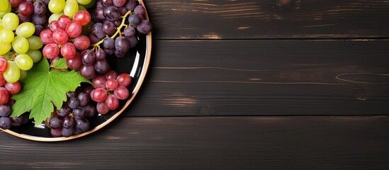 Aufkleber - top view of various types of grapes on vintage plate on black wooden surface. Creative banner. Copyspace image