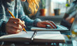 © Bartek - Student writing notes from online class on notebook with laptop, studying e-learning course, planning business event, making to-do list reminder