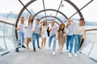 © Vasil - A group of young people are posing for a picture in a tunnel. Scene is lighthearted and fun, as the group is enjoying themselves and posing for the camera