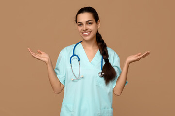 Poster - Portrait of female doctor shrugging on beige background