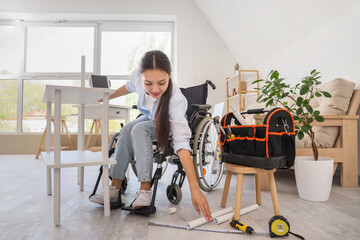 Wall Mural - Young Asian woman in wheelchair assembling shelf unit at home