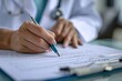 © PTC_KICKCAT - Medical professional filling out paperwork in a modern office setting. Focused on documentation and patient care with attention to detail.