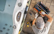 © Tomasz Zajda - Hot Tub Technician Repairing Jets