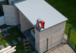 © Tomasz Zajda - Worker Installing Roof on Wooden Shed