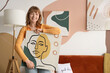 © Pixel-Shot - Young woman with stylish painting at home