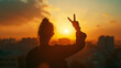© MYKHAILO KUSHEI - the silhouette of a girl who, looking at the city and the sun setting over it, shows two fingers as a sign of peace and acceptance of the rules of life