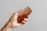 Hand Holding Comb