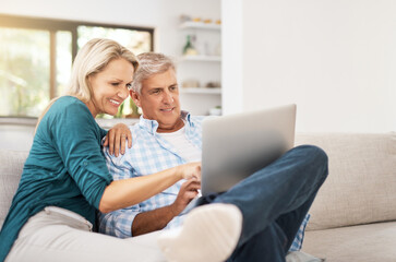 Poster - Couple, couch and laptop with smile in home, streaming and relax in living room for movies. Internet, computer and point for website for video with married people, calm and lounge with technology pc