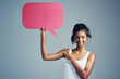 © Allistair/peopleimages.com - Girl, speech bubble and studio in portrait for social media, pointing and opinion on blue background. Text box, female person and review or vote on online post, networking and mockup on topic