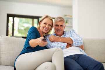 Poster - Sofa, couple and portrait with tv remote in living room for streaming service, entertainment and search. Mature man, woman and relax at home with television for online movie, film and media broadcast