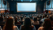 © AiDesign - Back view of audience in cinema or conference hall looking at blank movie screen