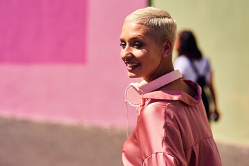 Poster - Woman, fashion and walking in outdoor, headphones and travel in city for style or radio sound. Female person, clothes and happy on street for streaming music on weekend, smile and downtown audio