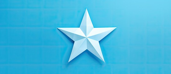 Wall Mural - origami star made of blue paper placed on a white background with copy space image.