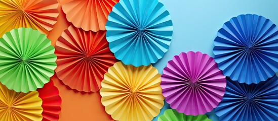 Poster - colorful origami papers forming circular shapes or fans to decorate a wall with copy space image.