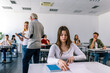 © Mediteraneo - Focused young woman taking notes from books for her study. College student sitting at desk and studying
