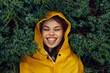 © SHOTPRIME STUDIO - Serene Woman Enjoying Nature's Beauty Tongue Out in Yellow Raincoat in the Enchanted Forest