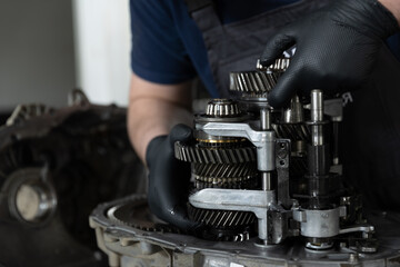 A craftsman who repairs mechanical parts of a car, close-up photo